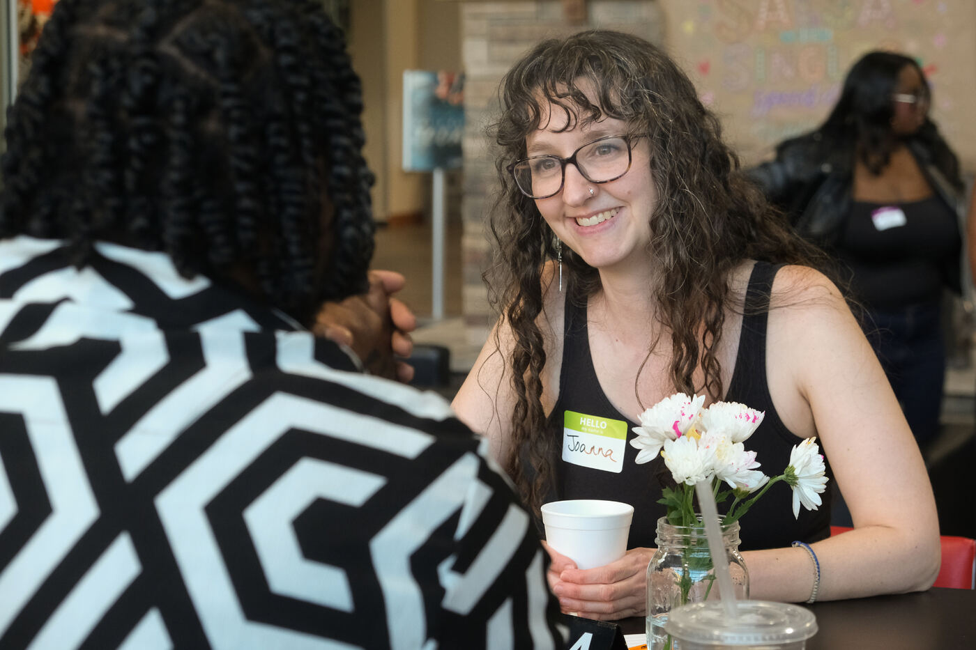 Joanna chatting at a speed dating table