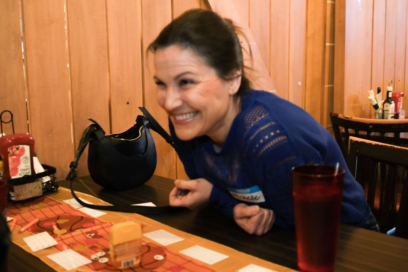 Michelle laughing at a speed dating table