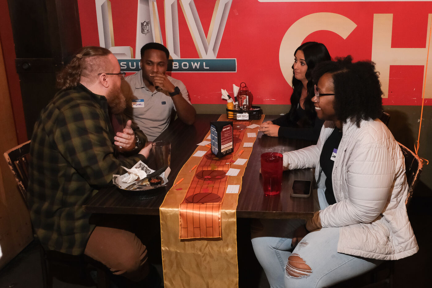 A group seated together at a football-themed Social Spark mixer